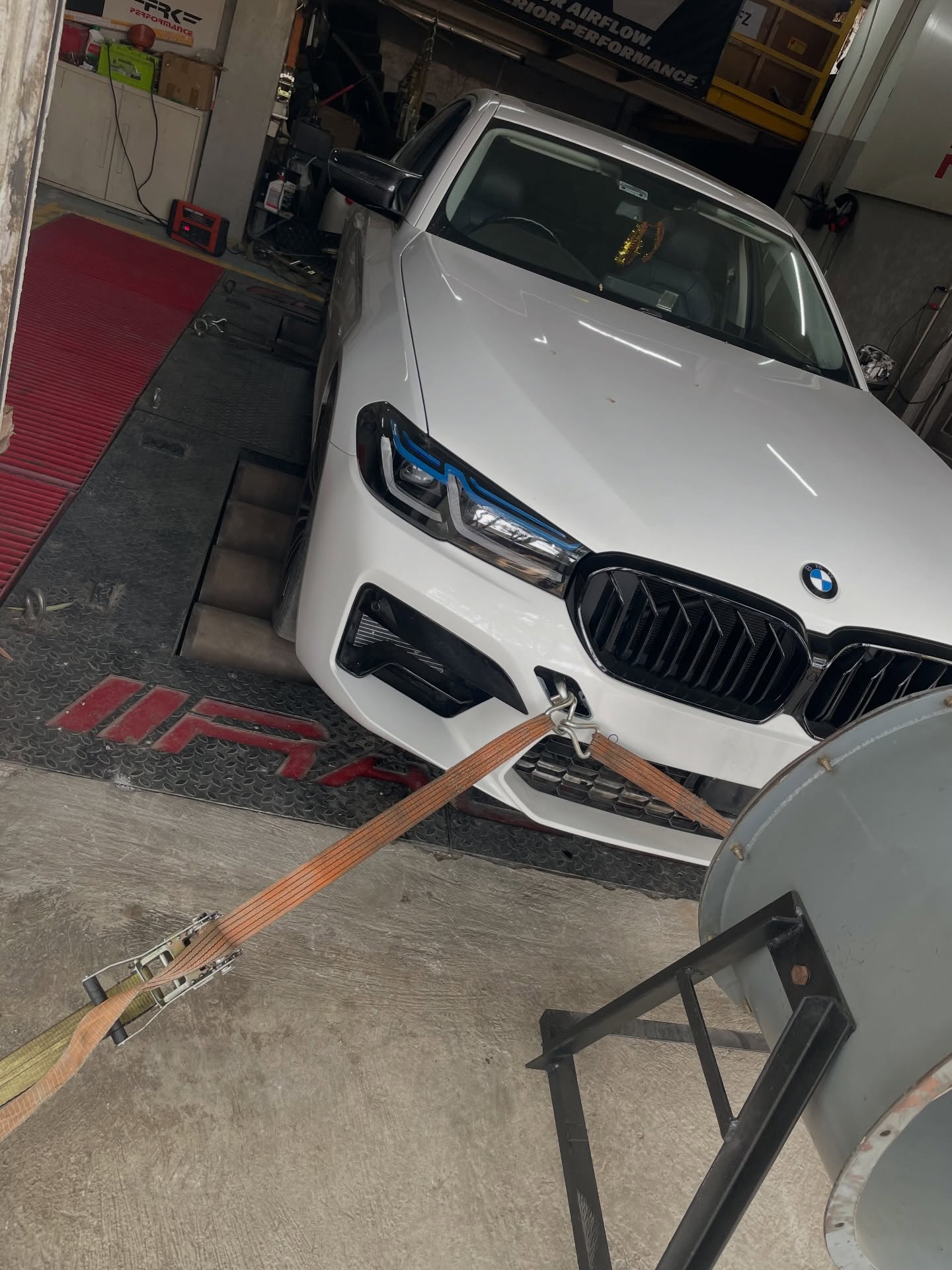 White BMW 530i on a dynamometer